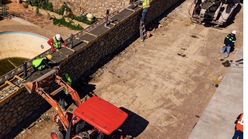 Crew pouring concrete on an ARM job site